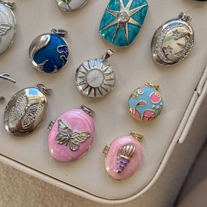 Detailed assortment of retro enamel pendants with butterfly and moon patterns in 18K gold