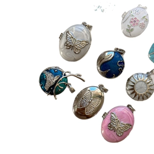Enamel heart locket pendants with 18K gold plating and colorful butterfly designs