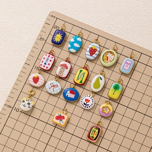 18K gold plated stainless steel sky and fruit enamel charms on a measuring grid