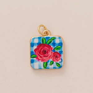 Detail of 18K gold plated stainless steel square pendant with blue plaid and red roses