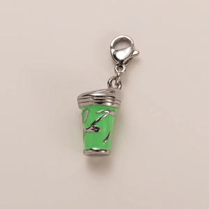 Detailed close-up of a silver coffee cup pendant with green enamel and lobster clasp