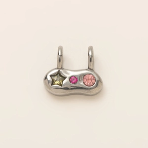 Macro view of silver stainless steel pendant with embedded colorful crystal stones