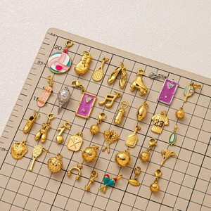 Sport themed 18K gold plated charms collection with lobster clasp on grid background