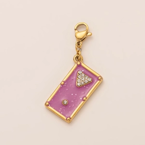 Detailed macro of 18K gold plated rectangular pendant with purple glitter and rhinestones