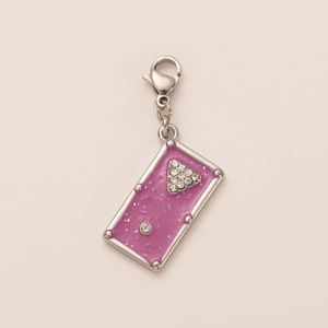 Macro shot of rectangular purple resin pendant with rhinestone triangle and silver lobster clasp