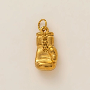 Macro detail of 18K gold-plated boxing glove pendant with realistic lace textures
