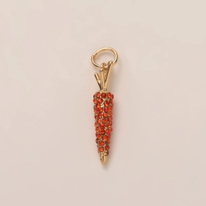 Detail view of carrot pendant featuring orange crystals and gold-plated metal finish
