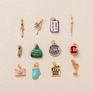 Close-up of 12-piece sports and lifestyle charms featuring camera and tennis racket