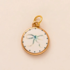 18K gold-plated round strawberry charm with a light blue ribbon bow and blue polka dots