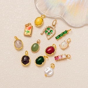Assorted gold-plated gemstone pendants including amethyst and clover with pearls