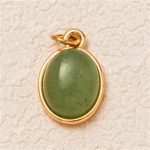 Close-up of oval green gemstone pendant with gold-plated frame and top bail for DIY necklaces