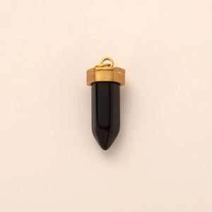 Detailed macro view of the hexagonal black onyx pendant with a polished 18K gold cap