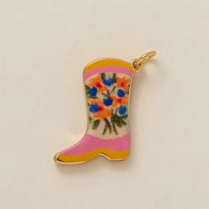 Detail of boot-shaped pendant featuring colorful floral enamel and golden metal finish