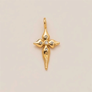 Detailed macro view of a gold-plated flower pendant with sparkling cubic zirconia stones