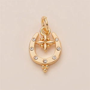 Detail of gold U-shaped pendant with inset zircons and hanging star charm accessory
