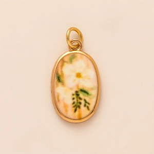 Close-up of vintage oval gold pendant featuring a white floral pattern and double rings