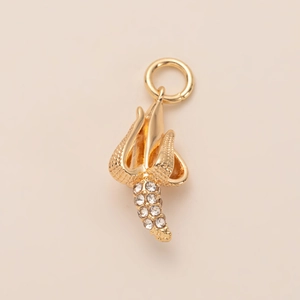 Detailed view of spiral gold pendant with pavé set rhinestones for DIY necklaces
