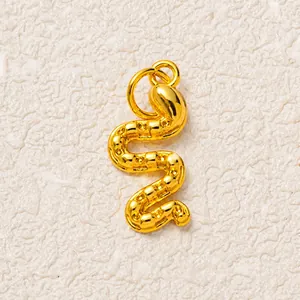 Detailed view of the gold snake pendant showing textured S-shaped scale patterns
