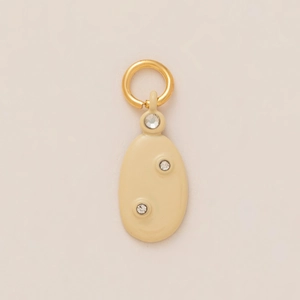 Detail of oval cream enamel pendant with three crystals and gold ring attachment
