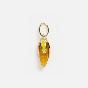 Macro detail of corn pendant with yellow resin grains and sparkling rhinestone crystals