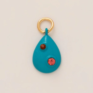 Close-up of a teal teardrop pendant with red gemstone accents and a gold-plated bail