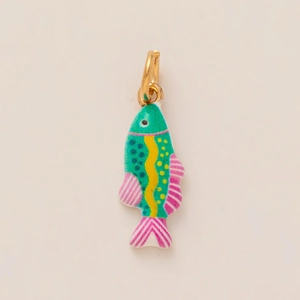 Detail of a colorful fish-shaped enamel pendant with vibrant green and pink patterns