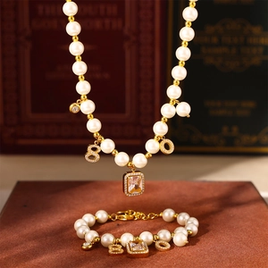 French vintage jewelry set with pearl necklace and bracelet featuring zircon pendants