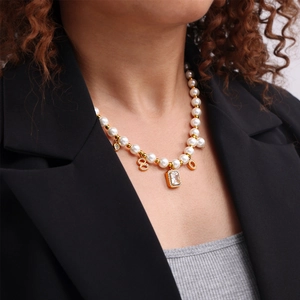 French vintage pearl necklace with golden number charms and rectangular zircon pendant