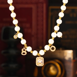 French vintage pearl necklace set with geometric gold pendants and sparkling zircon stones