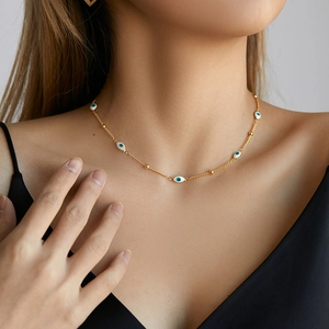 Gold Evil Eye beaded necklace for women featuring white enamel charms and small metal beads