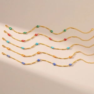 Vue détaillée de cinq chaînes Hamsa dorées avec breloques yeux en émail coloré