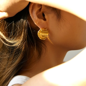 Vintage 18K gold-plated double layered round earrings with textured wave finish on model