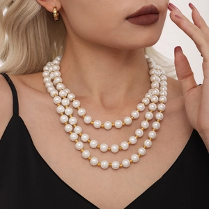 Three-layer faux pearl necklace with gold beads and matching C-shaped hoop earrings