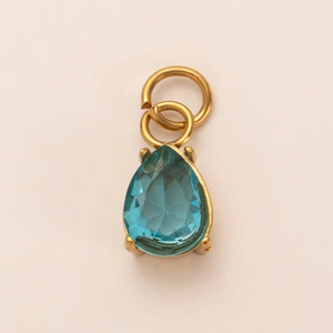 Detail of pear-cut light blue stone pendant in 18K gold-plated stainless steel base