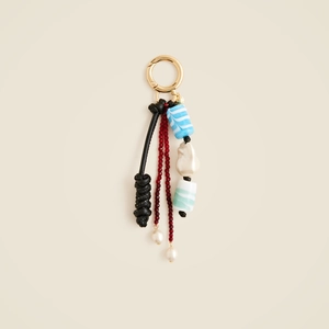 Vintage starfish and fish bag pendant with golden clasp and black woven knot