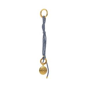 Macro shot of blue and white woven rope charm with gold evil eye metal pendant