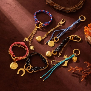 Flat lay of retro woven rope bag charms with gold pendants and colorful cord details