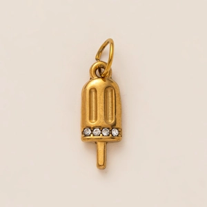 Macro shot of vintage gold popsicle pendant with four clear cubic zirconia stones
