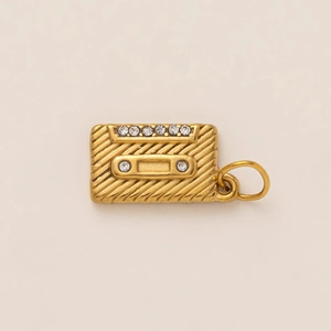 Detailed view of vintage gold cassette tape pendant with sparkling zircon inlays