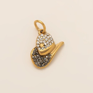 Macro detail of a gold cowboy hat pendant with sparkling rhinestones and a star charm