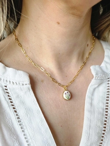 Close-up of 18K gold plated chain with retro oval pendant featuring hand-painted purple flowers