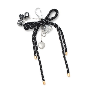 DIY bow keychain with woven rope, black dice charms and silver heart pendants in 18K gold finish