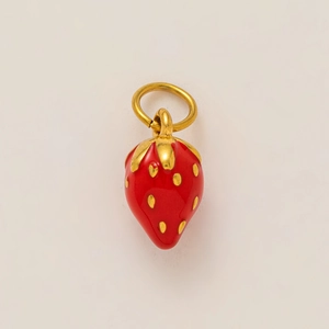 Close-up of strawberry pendant charm with red enamel finish and golden seeds for DIY jewelry