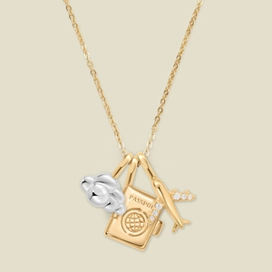Chic gold and silver travel necklace featuring passport, cloud, and crystal plane charms