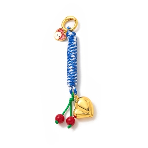 Detail of DIY keychain with gold heart charm, red cherry decor, and blue woven rope
