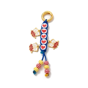 Detail of DIY keychain with braided rope, gold clasp, and heart cat enamel charms