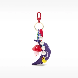 Detail of colorful bag charm with purple moon pendant, mushroom and pearl beads decoration
