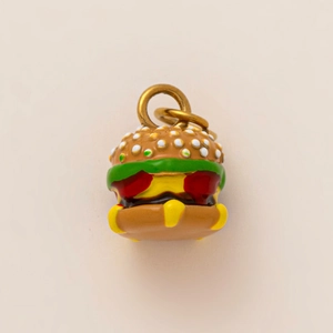 Macro shot of 3D burger pendant with 18K gold plating and colorful enamel detail