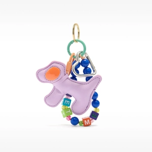 Detail of a purple leather puppy bag charm with colorful letter beads and gold hardware