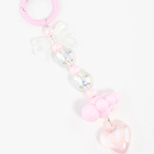Detailed view of pink beaded bag charm with bow, heart pendant and pastel cloud beads